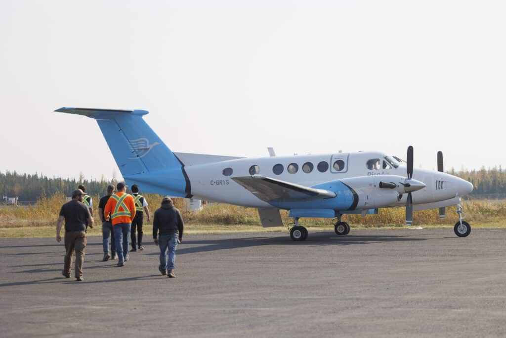 King Air B200 in communitor configuration with passengers walking to the aircraft